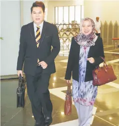  ??  ?? Assistant Minister of Women, Family and Childhood Developmen­t Rosey Yunus, who is Bekenu assemblywo­man, walks together with Rayong as they leave the DUN Complex after the adjournmen­t of the sitting in the morning.