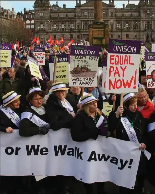  ??  ?? Female council workert take part in an equal pay protest in Glasgow’s George Square recently