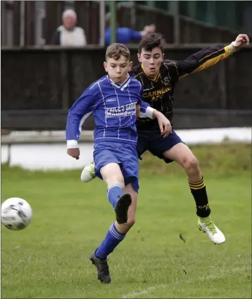  ??  ?? Ahron Smith of Roundwood is tracked by Michael Sullivan of Carnew during their U-14 Group C game.