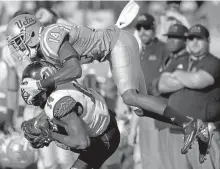  ?? MARK J. TERRILL/ASSOCIATED PRESS ?? Utah’s Brian Allen intercepts a pass intended for UCLA’s Theo Howard during the second half of the Utes’ 52-45 win against the Bruins.