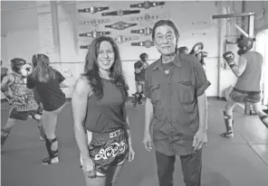  ??  ?? Master Lek and Short North Muay Thai owner Hope Vitellas work with students at the Grandview-area gym. Lek mentored Vitellas when she first discovered the sport in the 1990s.