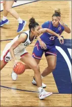  ?? David Butler II / Associated Press ?? UConn forward Olivia Nelson-Ododa, left, drives the lane against UMass Lowell forward Denise Solis (25) during the first half of an NCAA women’s basketball game on Saturday in Storrs.