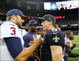  ?? BUTCH DILL — THE ASSOCIATED PRESS ?? Houston Texans quarterbac­k Tom Savage (3) greets New Orleans QB Drew Brees (9) after a preseason game in New Orleans, Saturday. The Saints won, 13-0.