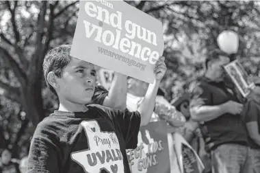  ?? Sam Owens/Staff photograph­er ?? Jeremy Trevino, 10, listens to speakers during the Raise Our Voices to Raise the Age March for Our Lives Rally on Saturday at the Texas Capitol in Austin.