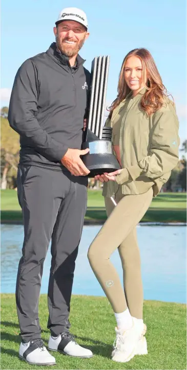  ?? MICHAEL REAVES/AGENCE FRANCE-PRESSE ?? DUSTIN Johnson shares the limelight with his wife Paulina Gretzky after ruling the LIV Golf Las Vegas by one stroke.