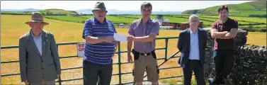  ??  ?? Terry O’Connor presenting a cheque for €800 to Frank Heidtke of Dingle Coast & Cliff Rescue on behalf of Thomas O’Callaghan who raised the money from sales of his CD ‘Take Two’, which was released last year. Joining the two at Ballintagg­art where the gates of the racecourse were closed on what would have been the Saturday of Dingle Races were, from left: Tom Browne, Thomas O’Callaghan and Donal Long of Dingle Coast & Cliff.