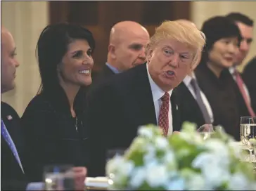  ?? The Associated Press ?? TRUMP SPEAKS: President Donald Trump, sitting next to U.S. Ambassador to the UN Nikki Haley, speaks during a working lunch with ambassador­s of countries on the United Nations Security Council and their spouses Monday in the State Dining Room of the...