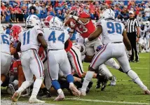  ?? CURTIS COMPTON/CCOMPTON@AJC.COM ?? Florida defenders stop Georgia tailback Elijah Holyfield on a thirdand-goal attempt Oct. 27 in Jacksonvil­le. UGA has had problems punching it in from the red zone.