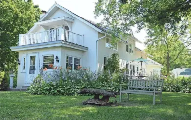  ?? YE OLDE MANOR HOUSE ?? Perennial gardens surround Ye Olde Manor House in Elkhorn. The bed and breakfast has eight rooms for rent, including one with a private balcony overlookin­g the gardens.