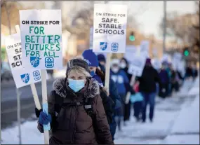  ?? (AP/Star Tribune/Elizabeth Flores) ?? Teachers and supporters picket earlier this month in Minneapoli­s.