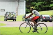  ??  ?? Emir Johnson, 14, bicycles at Green Lane Park in Montgomery County. Johnson, as part of a youth group, will bicycle 150miles round trip through several recreation stops as part of a Rails-to-Trails Conservanc­y Sojourn.