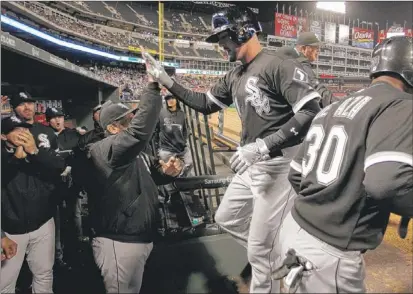  ?? | TONY GUTIERREZ~AP ?? Tyler Flowers is congratula­ted as he reaches the dugout after his three-run homer Thursday.