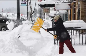  ?? PHOTOS BY BROOKE HESS-HOMEIER — THE ASSOCIATED PRESS ?? Snow is cleared from sidewalks in front of businesses during a snowstorm Saturday in downtown Truckee.