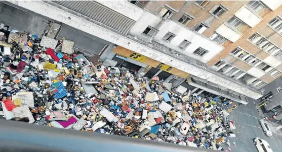  ?? /Twitter ?? Unsheltere­d: The possession­s of residents of Fattis Mansions in Johannesbu­rg’s inner city lie in the street after residents’ evictions on July 19 even though many of them owned their flats.