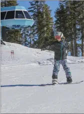  ?? Shelly Thorene / Union Democrat (above and below right); ?? Rachel Delise, 13, of Sonora (above) sets off down Quicksilve­r slope with her father, Mario, on a snowboard and brother Alex, 10, on skiis, not far behind. An undated photo shows a ski patroller on steeps at Dodge Ridge (above right). Dodge Ridge Ski Resort employee Sean Waterman, 52 (right), tries out Quicksilve­r slope on Monday.