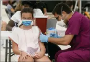  ?? MARTA LAVANDIER — THE ASSOCIATED PRESS ?? Francesca Anacleto, 12, receives her first Pfizer COVID-19 vaccine shot from nurse Jorge Tase, Wednesday, Aug. 4, in Miami Beach, Fla. On Tuesday, the CDC added more than 50,000new COVID-19cases in the state over the previous three days, pushing the seven-day average to one the highest counts since the pandemic began, an eightfold increase since July 4.