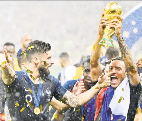  ?? Martin Meissner / Associated Press ?? France’s Olivier Giroud, left, and Corentin Tolisso celebrate after beating Croatia in the World Cup final in Moscow on Sunday.