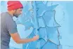  ?? Supplied ?? POTGIETER paints the mural with precision and passion. |