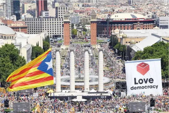  ??  ?? A Catalan pro-independen­ce flag flutters as thousands of people take part in a recent demonstrat­ion in Barcelona in favor of Catalonia breaking away from Spain. (AFP)