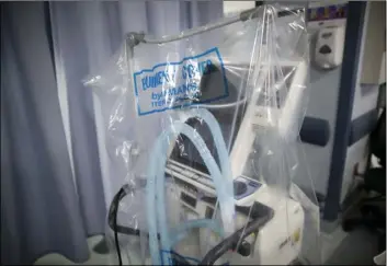  ?? AP PHOTO/JOHN MINCHILLO ?? In this April 20, file photo a ventilator waits to be used for a COVID-19 patient going into cardiac arrest at St. Joseph’s Hospital in Yonkers, N.Y.