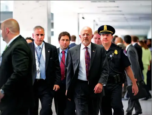  ??  ?? SECURITY LEAKS: Director of National Intelligen­ce James Clapper, center, emerges from a closed- door meeting with the House and Senate Intelligen­ce Committees aimed at stopping security leaks Thursday on Capitol Hill in Washington.