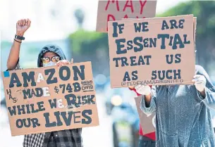  ?? VALERIE MACON AFP VIA GETTY IMAGES FILE PHOTO ?? Some Amazon workers, who joined protests on May 1, said they were upset over the end of the firm’s policy of unlimited unpaid time off, which many had used to avoid exposure inside warehouses.