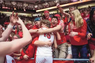  ?? CHANCEY BUSH/JOURNAL ?? Albuquerqu­e Academy’s Garrett Garcia (15) celebrates with fans after the Chargers defeated Hope Christian on Saturday in the 4A boys state championsh­ip game at the Pit.