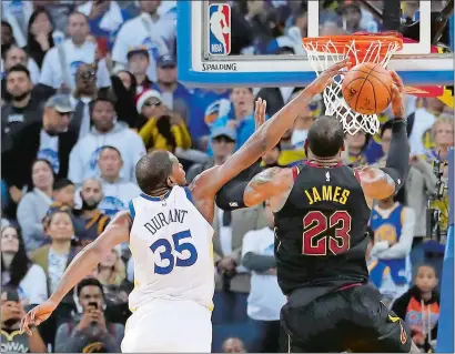  ?? TONY AVELAR/AP PHOTO ?? Golden State Warriors forward Kevin Durant (35) blocks a shot by Cleveland Cavaliers forward LeBron James (23) during the second half of Monday’s game at Oakland, Calif. The Warriors won 99-92.