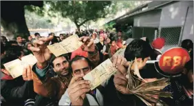  ?? Express ?? People queue up to deposit demonetise­d notes outside the RBI in New Delhi.