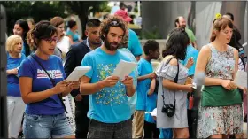  ?? NWA Democrat-Gazette/ANDY SHUPE ?? Residents sing Saturday during the rally.