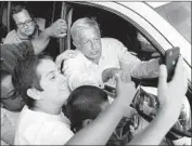  ??  ?? SUPPORTERS get selfies with the candidate in Tultitlan. “A lot of people joke that we are voting for [him] out of desperatio­n,” said one. “I think it’s true.”