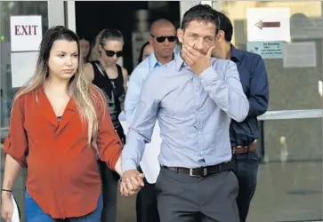  ?? Photograph­s by Al Seib Los Angeles Times ?? MARCUS KOWAL and his wife, Mishel Eder, leave court in July. Kowal, a mixed martial arts fighter, became active in campaigns against drunk driving after his son, Liam Mikael Kowal, was killed in September.