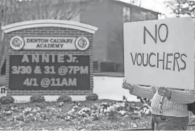  ?? ?? A woman holds a sign opposing school vouchers outside Denton Calvary Academy on March 27, 2023. Two Denton ISD principals have been indicted on allegation­s that they encouraged their staffs to vote against political candidates who support school choice.