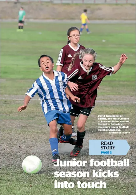  ?? JOHN BISSET/STUFF ?? David Tuliakiono, of Thistle, and Maia Crosbie, of Pleasant Point, contest the ball in Saturday morning’s junior football match at Anzac Sq.