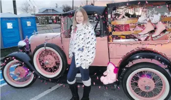  ??  ?? Anna Dean shows off her 1929 Ford Model A roadster pickup all decorated for the Surrey Santa Parade.