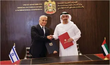  ?? (Shlomi Amsalem/GPO/Reuters) ?? FOREIGN MINISTER Yair Lapid and UAE Foreign Minister Sheikh Abdullah bin Zayed al-Nahyan shake hands in Abu Dhabi on June 29.