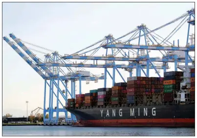  ?? (AP) ?? Cargo cranes unload a Yang Ming Marine Transport Corp. container ship at the Port of Tacoma in Washington state. Tuesday’s announceme­nt marked the third Chinese tariff cut since a trade agreement with the U.S. was reached in January.