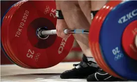  ??  ?? A weightlift­er steadies himself during the Tokyo 2020 Olympic Games. More than 600 lifters have tested positive for doping in the past decade. Photograph: Alexander Nemenov/ AFP/Getty Images