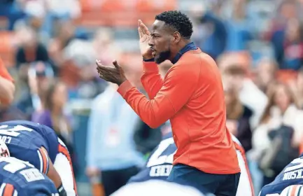  ?? BUTCH DILL/AP ?? Auburn interim head coach Carnell Williams encourages players during warmups before a game against Western Kentucky on Saturday in Auburn, Ala.