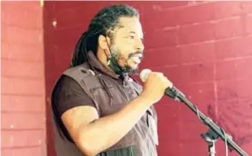  ??  ?? (Above) Organizer Vashaun Ferguson speaks to the crowd gathered at Moncrief Park Friday.