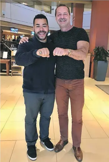  ??  ?? Ex-Eskimo Milson Jones’ son, Devon, left, displays his father’s 1987 Grey Cup ring alongside Ottawa businessma­n Walter Pamic, who bought the ring at an auction in the mid-1990s and wanted to return it to Jones at no cost.