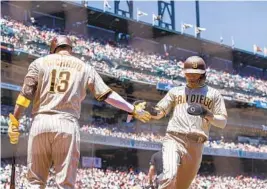  ?? JOHN HEFTI AP ?? Padres’ Ha-seong Kim, who went 2-for-5 with an RBI, celebrates with Manny Machado after scoring a run against the Giants during the second inning.