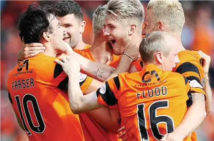  ??  ?? Fab Fraser: the United midfielder (left) is mobbed by team-mates after his free-kick gave the hosts a 2-0 lead