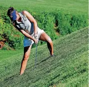  ?? STEVE SISNEY, THE OKLAHOMAN] [PHOTO BY ?? Auburn’s Elena Hualde hits from the side of a hill on the third hole Friday in the NCAA Women’s Golf Championsh­ips at Karsten Creek Golf Club in Stillwater.