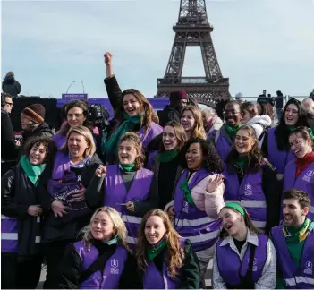  ?? ?? Activists of the ‘Fondation des Femmes’ women’s rights group gather in front of Eiffel Tower at the Place du Trocadero in Paris, during the broadcasti­ng of the convocatio­n of both houses of parliament to anchor the right of abortion in the country’s constituti­on.