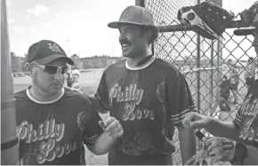  ?? JOSHUA A. BICKEL/COLUMBUS DISPATCH ?? Philly Love player Chad Harris, center, greets teammate Chris Vorgity, left, after Vorgity scored Wednesday during a game against the Dallas Boxcutters at the Gay Softball World Series.