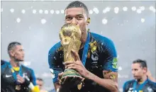  ?? MATTHIAS HANGST GETTY IMAGES ?? France’s Kylian Mbappé celebrates with the World Cup trophy.
