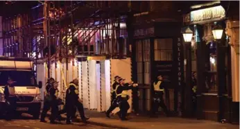  ?? CARL COURT/GETTY IMAGES ?? Armed police raid The Blue Eyed Maid in Borough Market, a restaurant district near London Bridge.