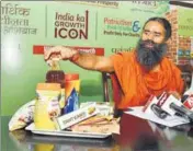  ??  ?? Baba Ramdev showcases his Patanjali products