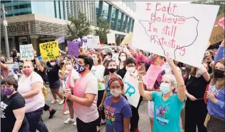  ?? Melissa Phillip / Associated Press ?? People participat­e in the Oct. 2 Houston Women's March against Texas abortion ban walk from Discovery Green to City Hall in Houston. A federal appeals court is temporaril­y allowing the nation’s toughest abortion law to resume in Texas. The 5th U.S. Circuit Court of Appeals handed down the order Friday.